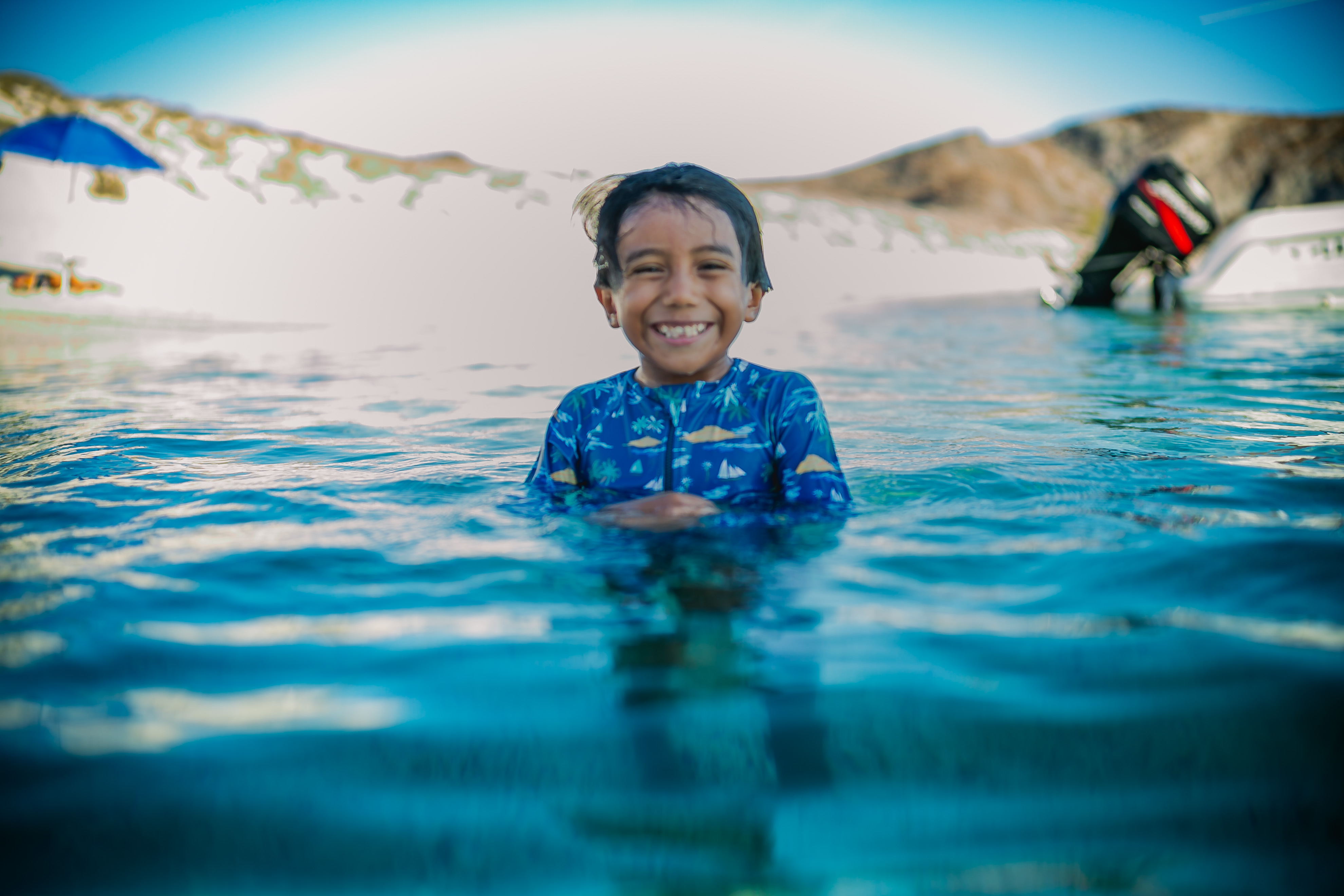 Niño sonriendo en las aguas transparentes del Mar de Cortés